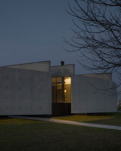 Casa Alba by Ademas Arquitectura, a concrete house with a wall for privacy