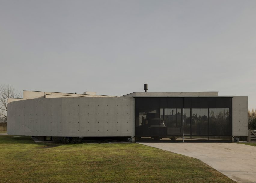 Casa Alba by Ademas Arquitectura, a concrete house with a wall for privacy