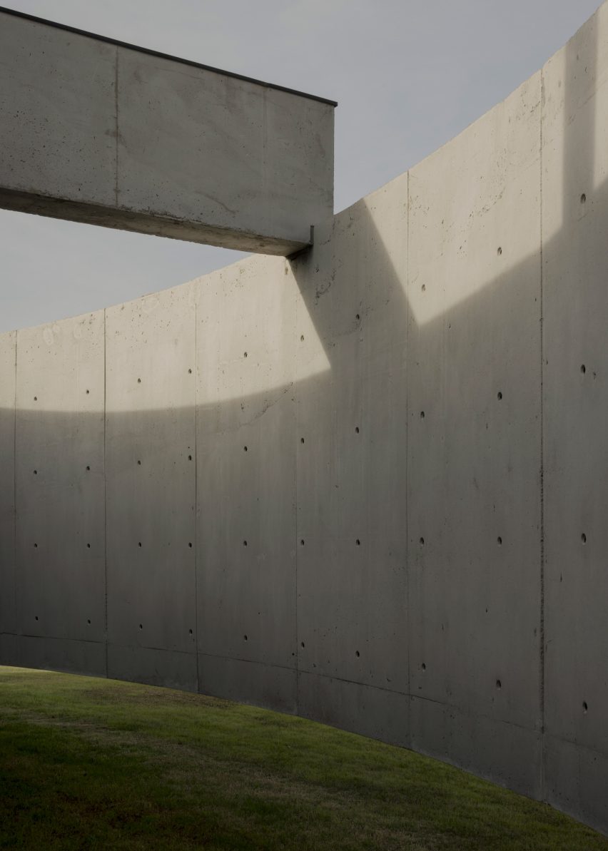 Casa Alba by Ademas Arquitectura, a concrete house with a wall for privacy