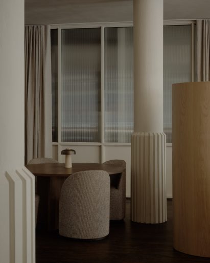 Structural columns wrapped in ridged flares around their bases