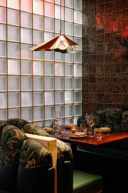 Booth seating next to a textured glass brick wall
