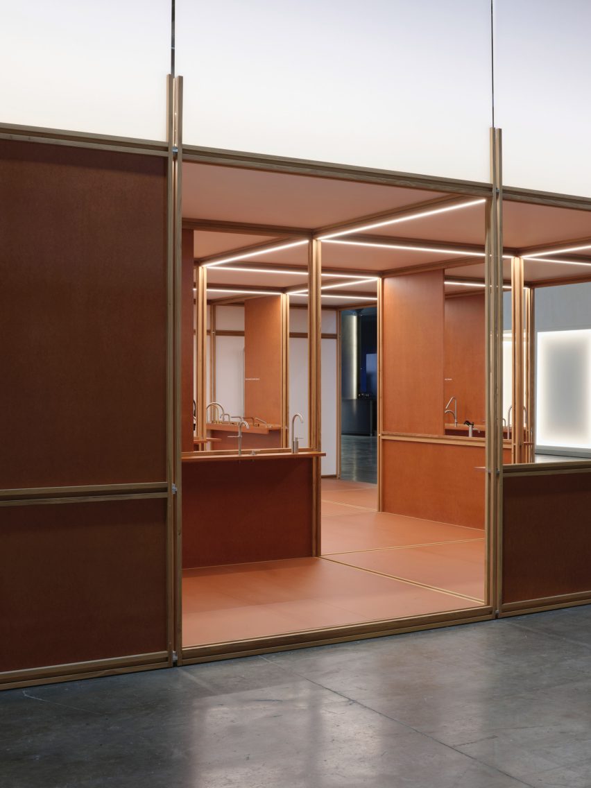Photo looking into the QuadroDesign booth at Salone del Mobile 2026 from outside, showing the open framework partly closed with partitions