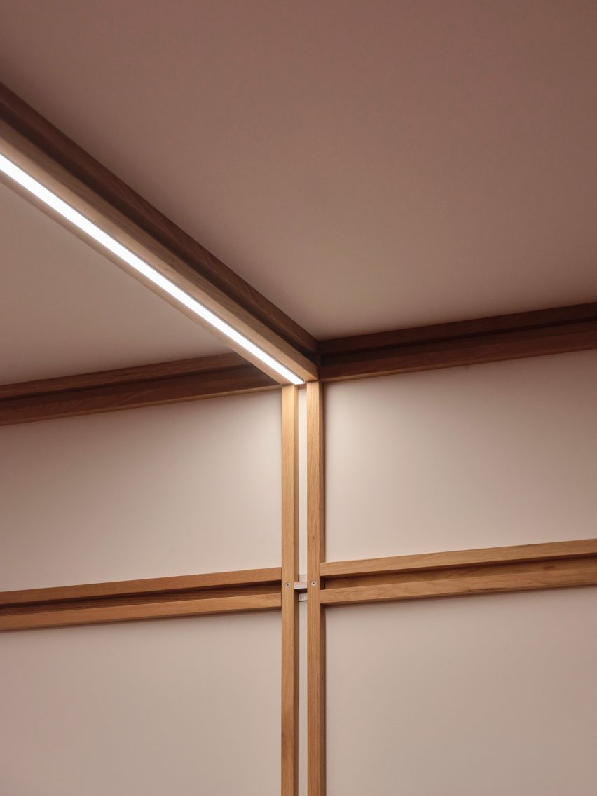 Close-up photo of the framework joining at the ceiling of the QuadroDesign booth at Salone 2026, with a lighting strip embedded in a cavity of the ceiling beam