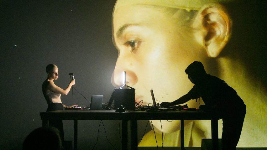 an image of student work from ie university, showing a projection of an image with people standing in front of it