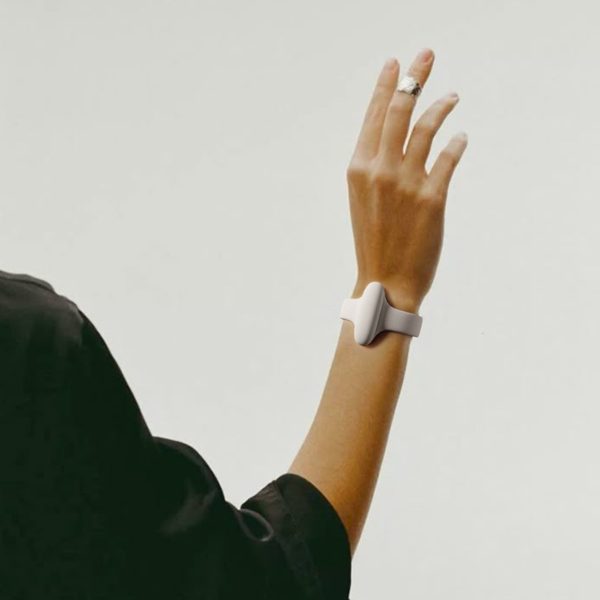 Person wearing the Nura bracelet, a wearable device designed to translate sign language into speech