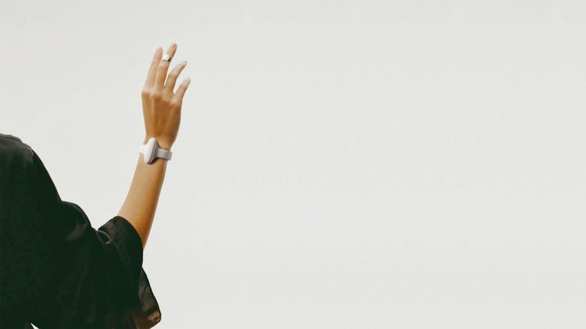 Person wearing the Nura bracelet, a wearable device designed to translate sign language into speech