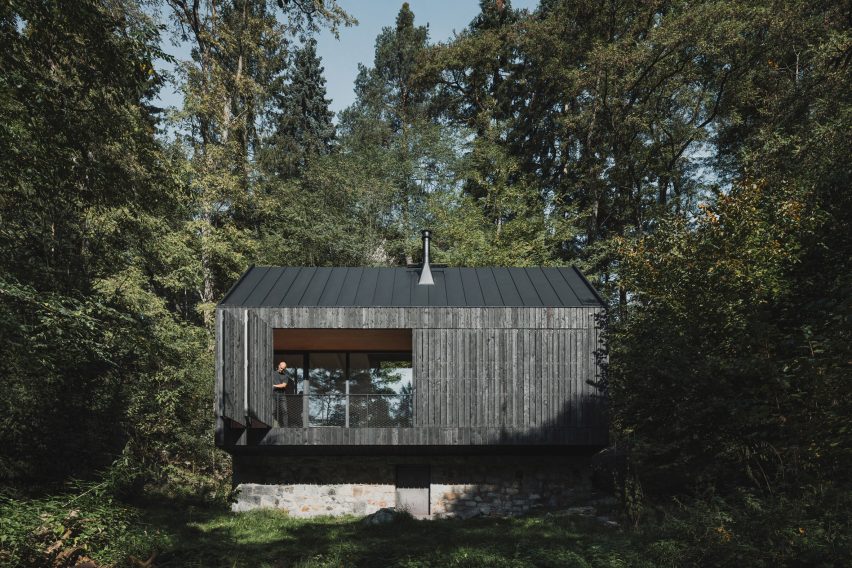Log cabin on stone plinth in Czech Republic