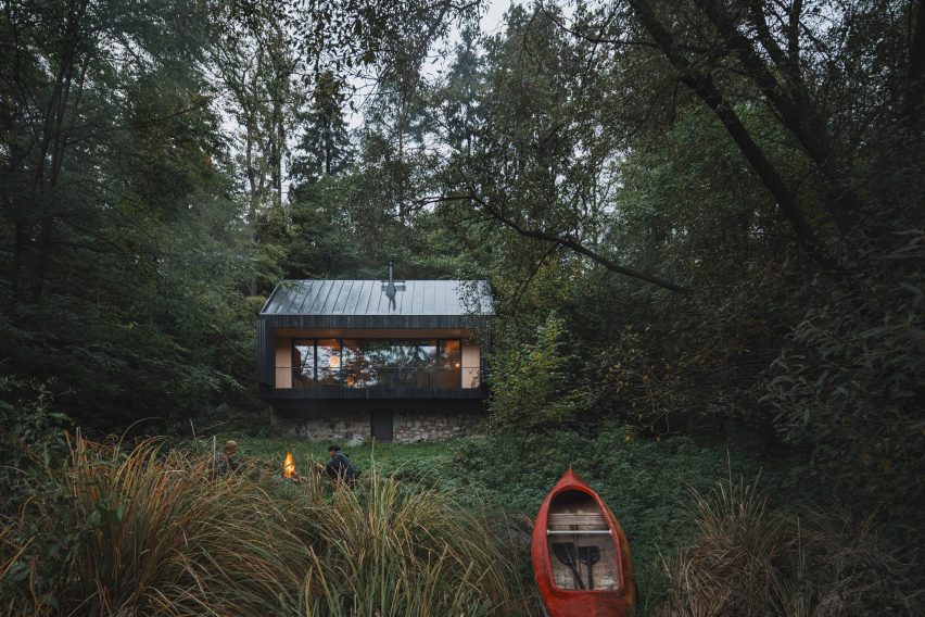 Wood cabin with river kayak