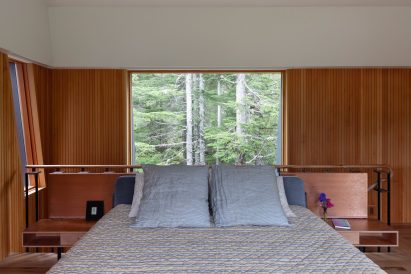 Bedroom with a window overlooking treetops