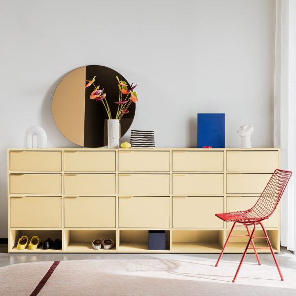 Photo of a yellow cabinet with mirror and red chair