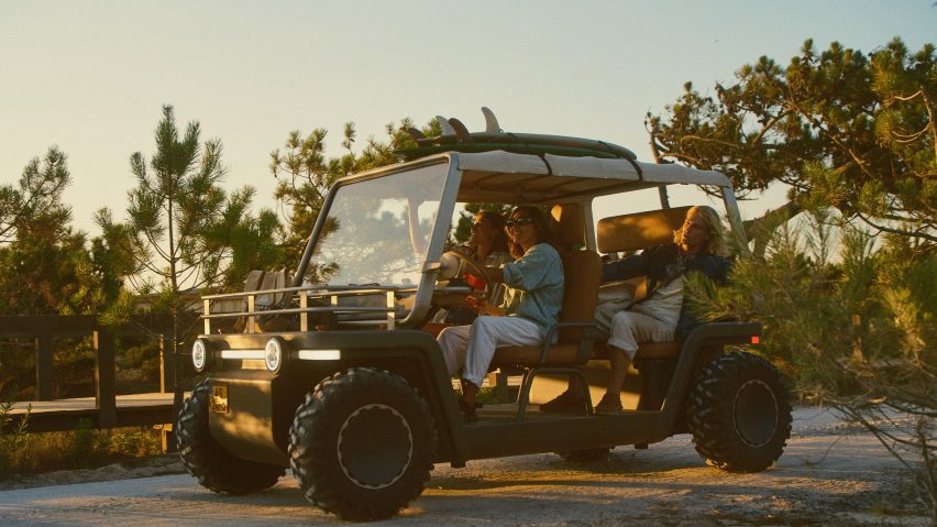 Lifestyle photo of a group of young people driving the Amble One buggy down a coastal path with surf boards strapped to the roof