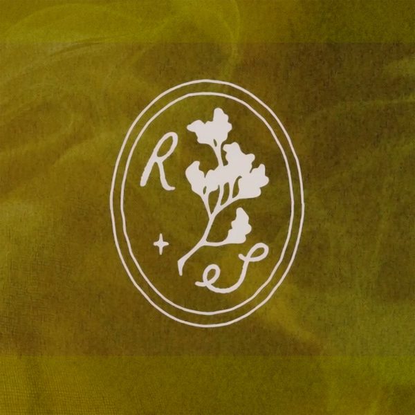 Hand drawn white logo on a yellow-green background