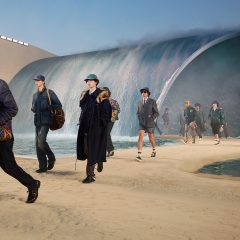 Models in front of large wave at Louis Vuitton show