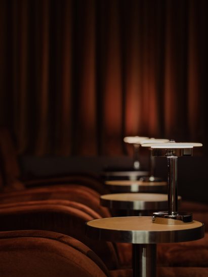 Tables against red curtain