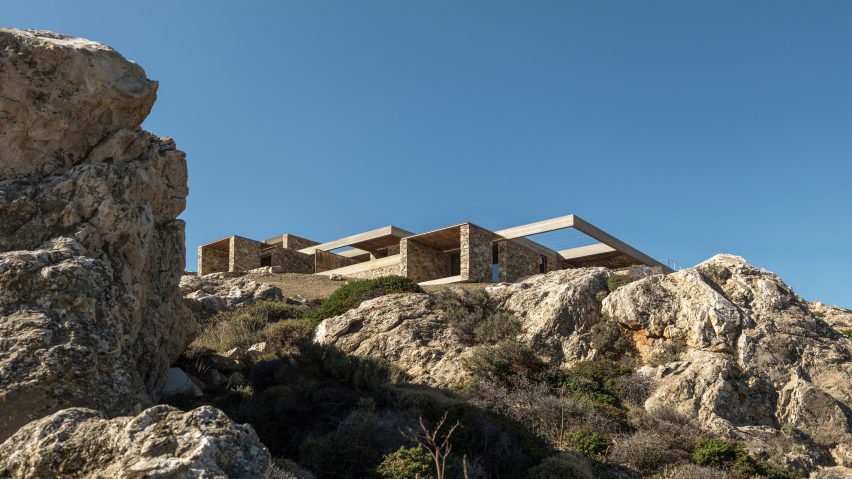 Stone-clad hospitality retreat embedded into a rocky hillside overlooking the Aegean Sea on Serifos