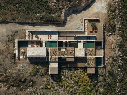 Aerial view showing pools, planted roofs and courtyards arranged within a concrete grid