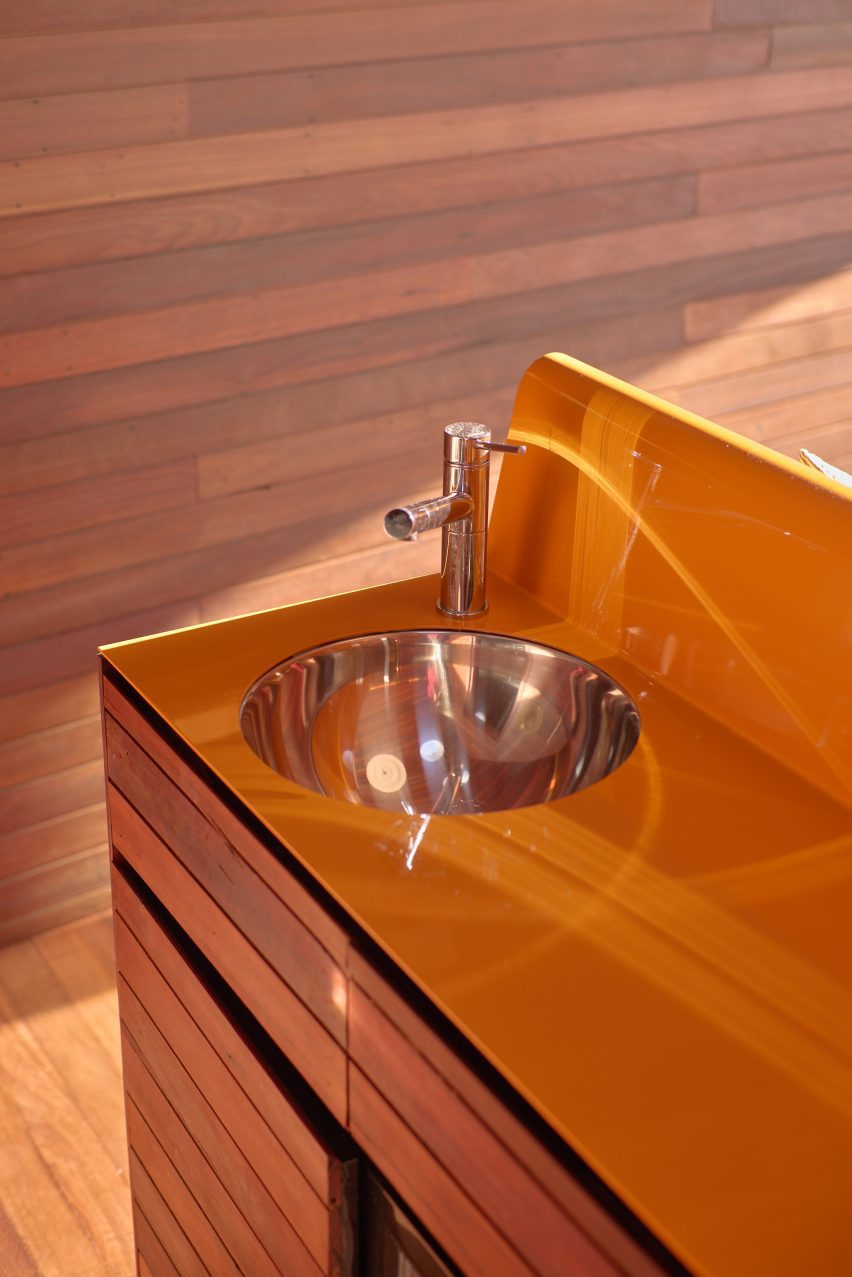 Orange painted kitchenette in PC3 by Casey Brown Architecture