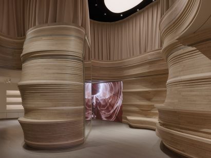 An LED wall display within a wood-wrapped store interior