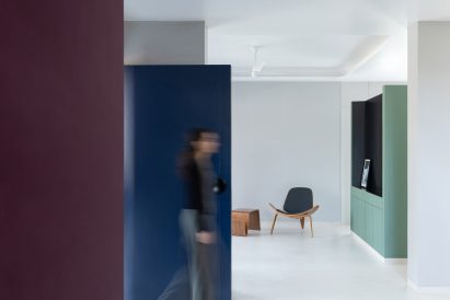 The white floors contrast the bold walls in Villa Corsica in Mumbai