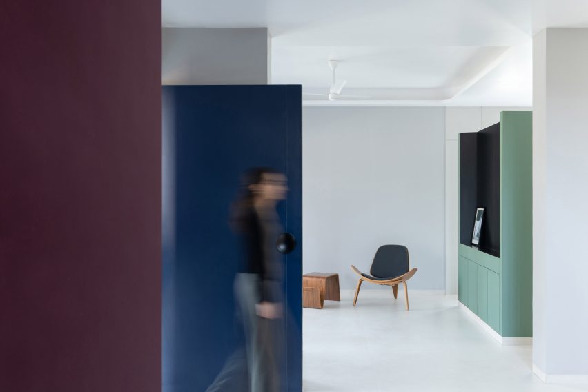 The white floors contrast the bold walls in Villa Corsica in Mumbai