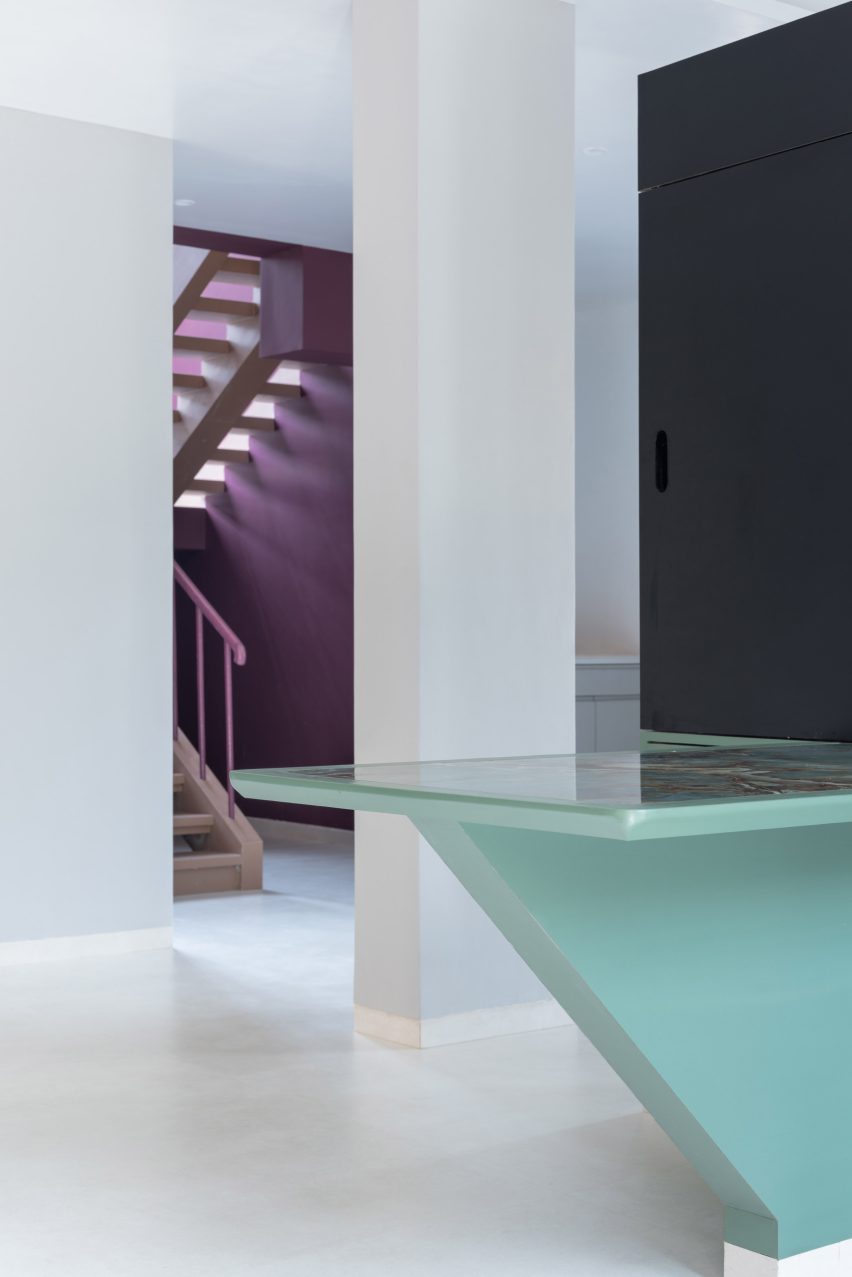 A partition acts as a dining table and television set in Villa Corsica