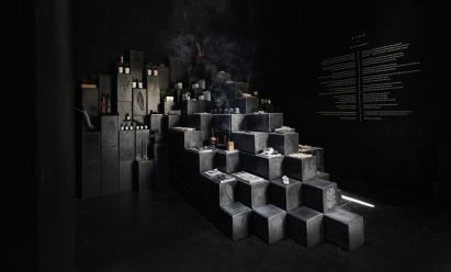 Black-cement blocks form a stepped display in a perfume showroom