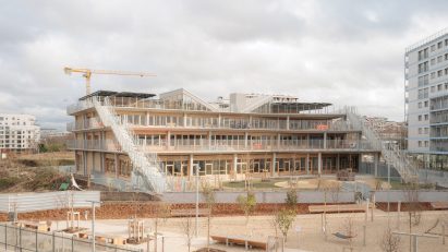 Exterior view of the stepped school building with cascading terraces and external staircases