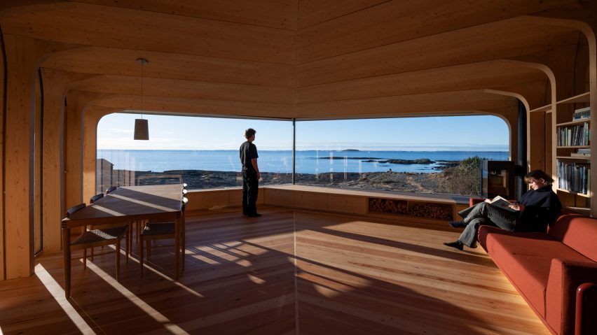 Timber living room with floor-to-ceiling glazing framing panoramic views across the Atlantic coastline