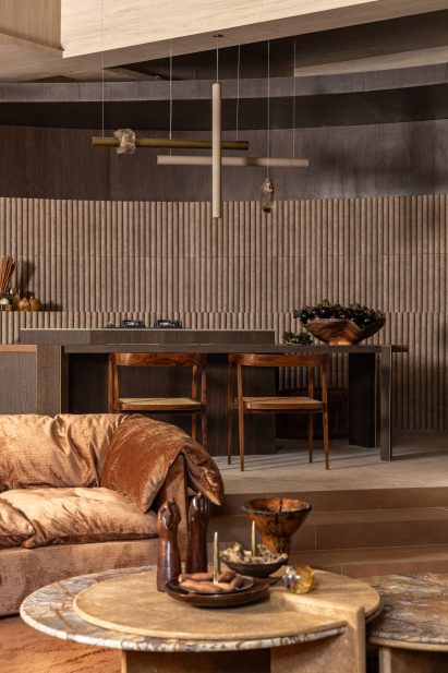 Portinari tiles form a backdrop for a custom pendant lamp and mid-century chairs