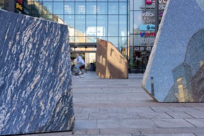 Close-up photo of cut stone surfaces reflecting the surrounding cityscape in Rana Begum's No.1574 Stone artwork in the Oulu city centre