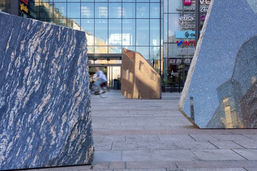 Close-up photo of cut stone surfaces reflecting the surrounding cityscape in Rana Begum's No.1574 Stone artwork in the Oulu city centre