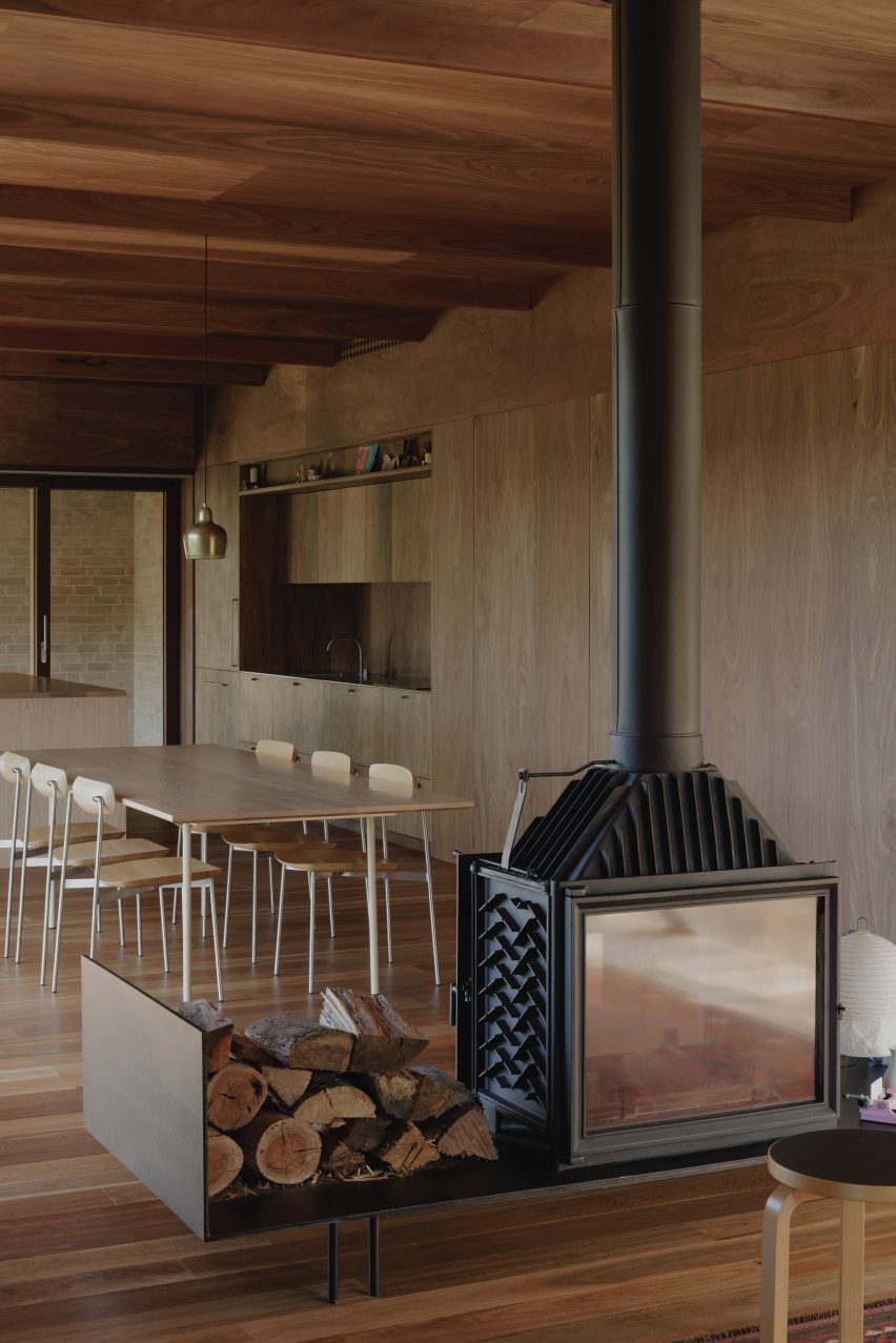 EA House by Bokey Grant fireplace and dining area
