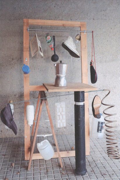 Sculptural structure with household items attached to it