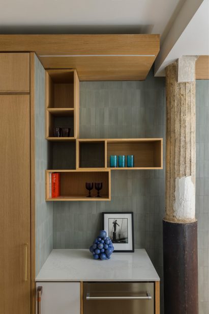 A factory building's original columns are incorporated into an apartment interior