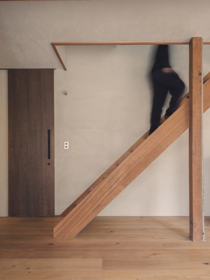 Staircase to upper floor within Japanese home by HYAN