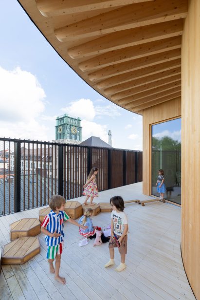 Children playing at the Kinderoase an der TUM by Kéré Architecture