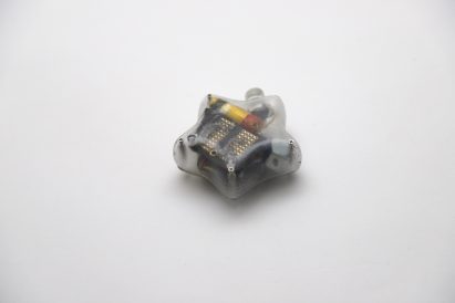 Photo of the back of a Mesh-89 unit with a transparent case, showing the components inside