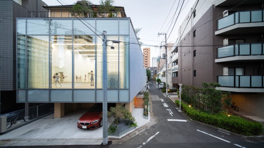 Exterior view of Tokyo Ballet House showing a large glazed ballet studio with dancers visible inside