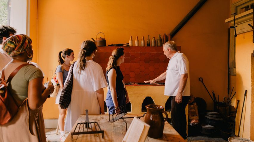 a group of people in an orange room
