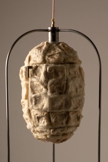 Close-up photo showing the bacterial cellulose xerogel insulating panels moulded with felted wool to make the exterior of the Xero Cool fridge, which has a cocoon-like appearance and is suspended in a frame
