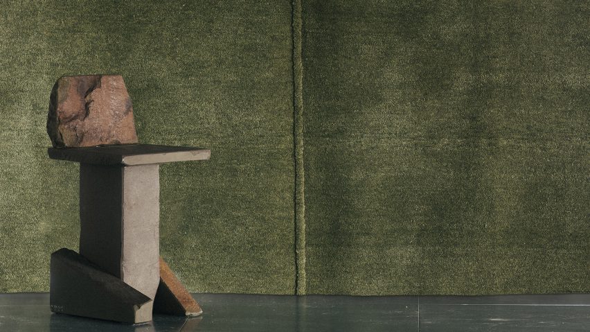 Photo of table in front of textile wall hanging