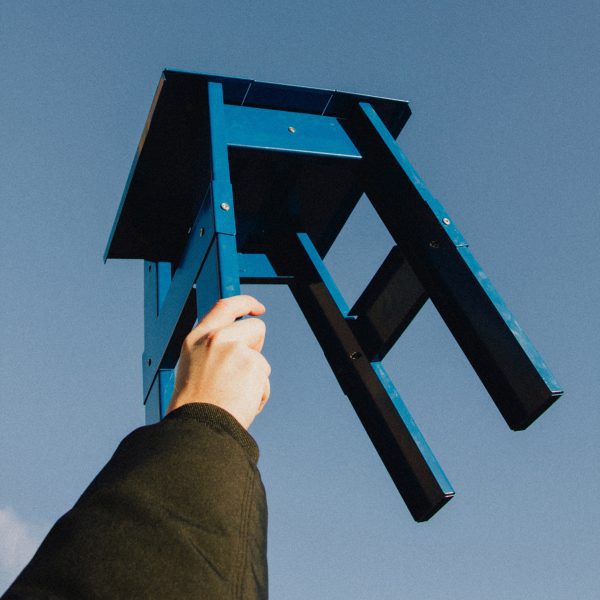 Photo of person holding a chair