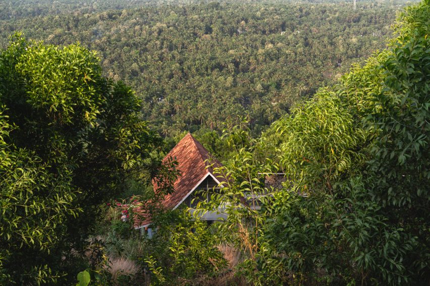Ushas farmhouse nestled into a forested landscape in Kerala