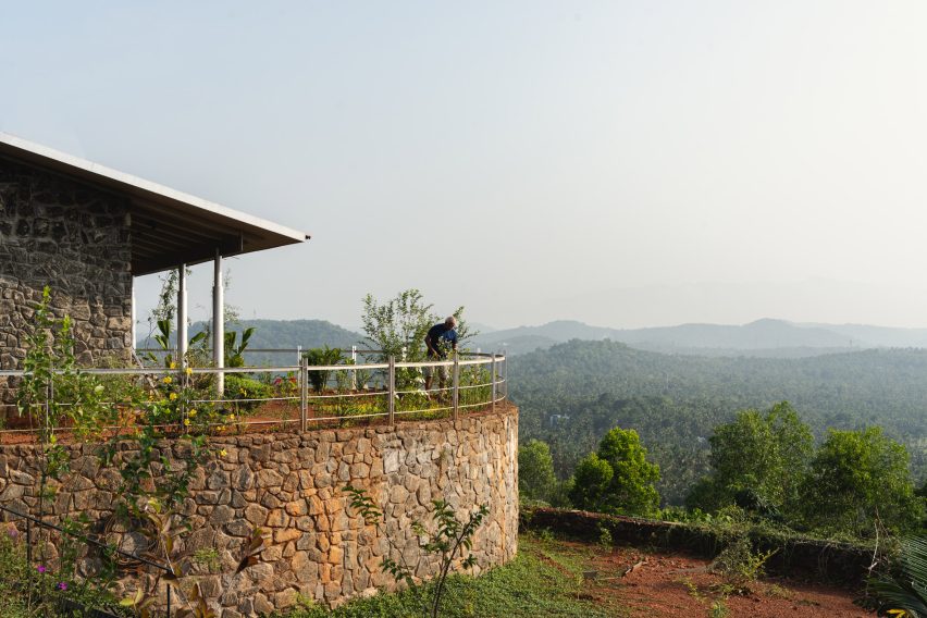Ushas farmhouse with stone walls overlooking a Kerala hillside