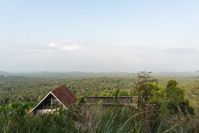 Ushas farmhouse overlooking a forested landscape in Kerala