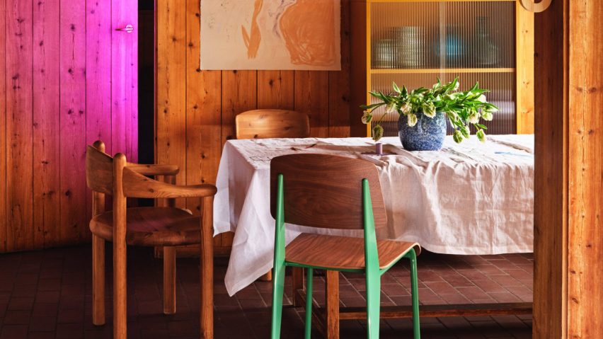 Photo of wooden chairs at a table in a wooden panelled room