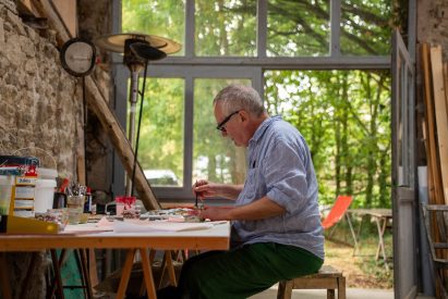 Paul Cox drawing an artwork