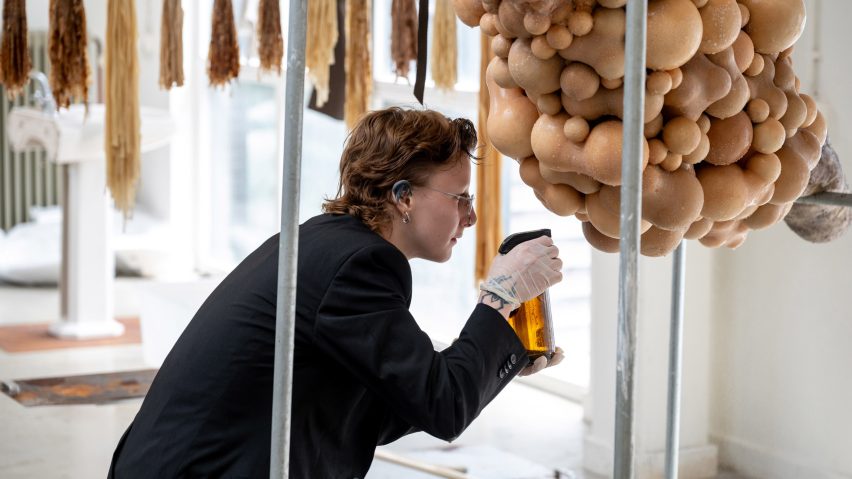 Student spraying a body-like installation