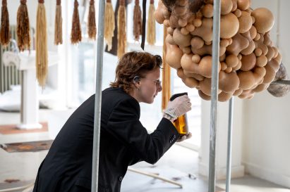 Student spraying a body-like installation