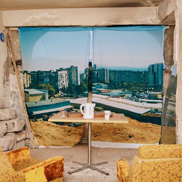 Photo of two chairs and a table with a kettle on it